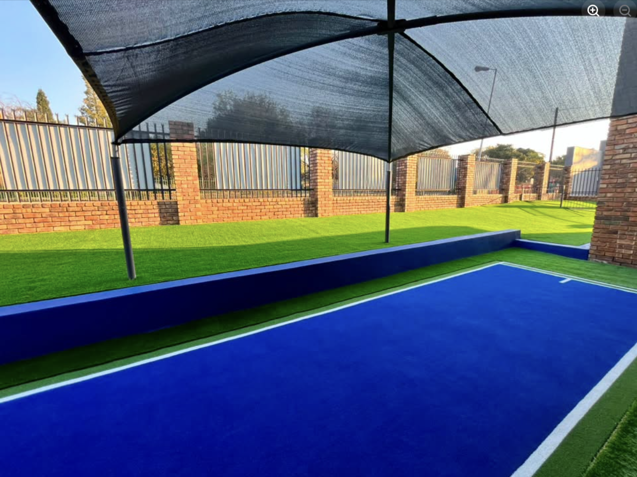 Artificial-turf lawn bowls green with shade sail canopy in Centurion